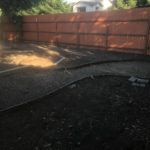 Before photo of an unfinished backyard with bare dirt and edging in Gridley CA prior to landscape installation by Cruzin Landscape