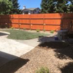 After photo showing completed backyard renovation with new grass, gravel, and concrete patio installed by Cruzin Landscape in Gridley CA